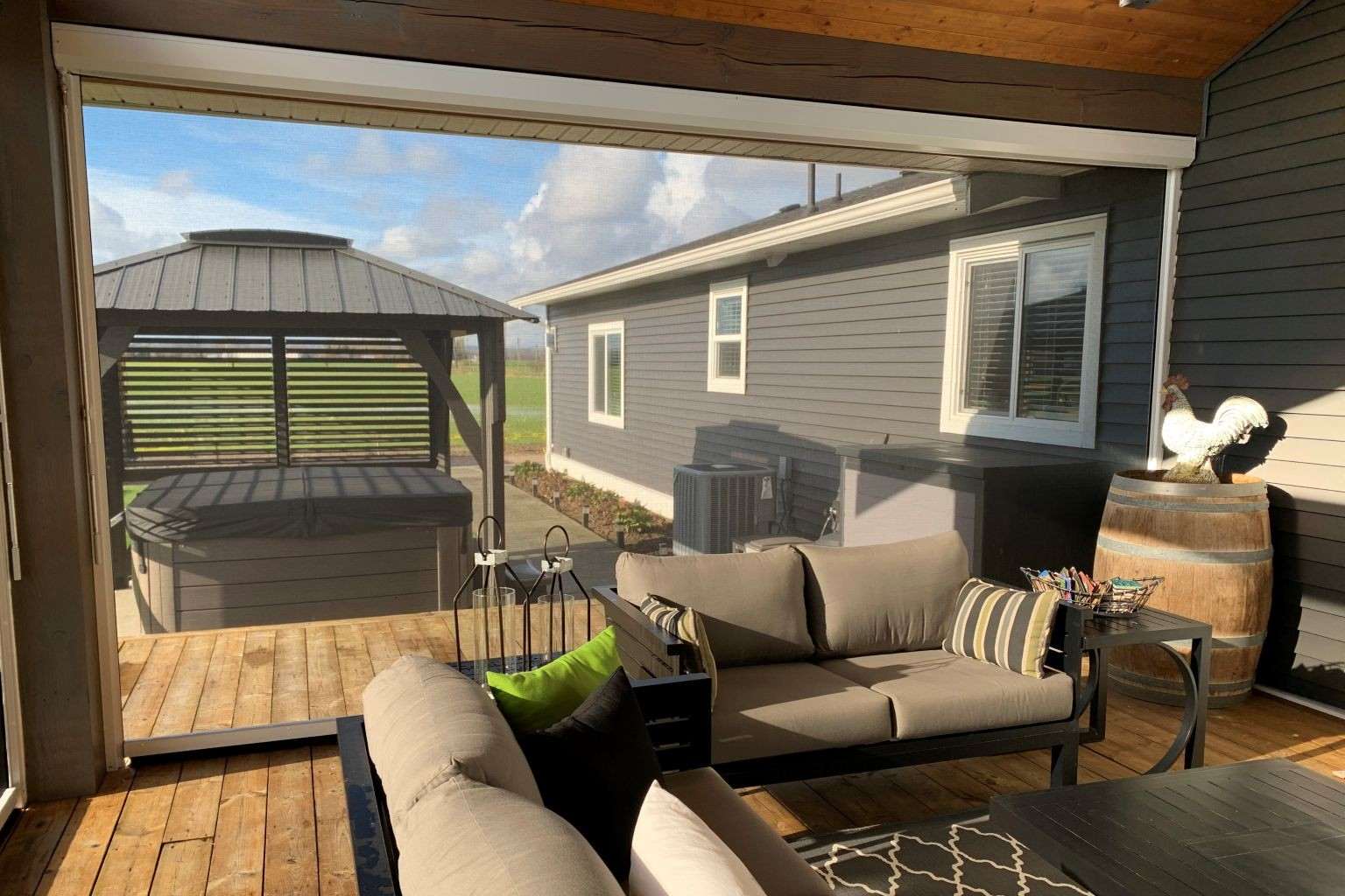 Elevated deck with retractable privacy screen coverage on the exposed side